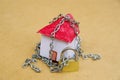 House in chains locked with padlock, mortgage and foreclosure concept Royalty Free Stock Photo