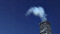 House chimney with smoke at snowfall night