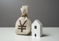 House and chinese yuan or japanese yen money bag. Investments in the purchase of real estate. Repair and service. Make a deal. Royalty Free Stock Photo