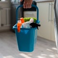 House cleaning concept. Faceless woman holds cleaning products in a blue basket. Closeup of the hands of a female Royalty Free Stock Photo