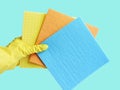 House Cleaning. Female hand in yellow glove cleaning window with multicolored rag. Hand in yellow glove with sponge . Royalty Free Stock Photo