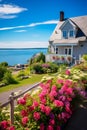 a house on the coast surrounded by flowers and plants and a wooden fence