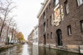 The Netherlands, Delft, October 2022. House with coat of arms, Hotel Arsenaal near the canal in Delft