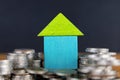 House on a coin pile, real estate investment, save money with a coin pile