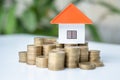 House and coins in the hands of investors.Orange roof house.Save money for buying a new home and borrowing money to plan the real Royalty Free Stock Photo