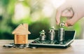 House on coins and house put on calculator. Man's hand putting home. planning savings money of coins to buy a home concept Royalty Free Stock Photo