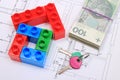 House of colorful building blocks, keys and banknotes on drawing of home Royalty Free Stock Photo