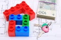 House of colorful building blocks, keys and banknotes on drawing of home Royalty Free Stock Photo