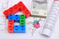 House of colorful building blocks, keys, banknotes and drawings Royalty Free Stock Photo