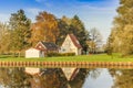 House and colorful trees reflected in the Winschoterdiep canal in Groningen