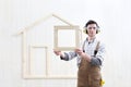 House construction renovation concept handyman carpenter worker man show the model of wooden house