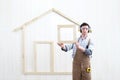 House construction renovation concept handyman carpenter worker man show the model of wooden house