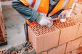 House construction site, worker building the brick wall with trowel, cement and mortar. Royalty Free Stock Photo