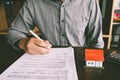 House Contract, Man signs a contract to purchase a home with a r Royalty Free Stock Photo
