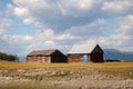 House in the countryside with the mountains in the background. Farm cabin in the rural country surrounded by forest and hills with Royalty Free Stock Photo