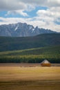 House in the countryside with the mountains in the background. Farm cabin in the rural country surrounded by forest and hills with Royalty Free Stock Photo