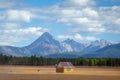 House in the countryside with the mountains in the background. Farm cabin in the rural country surrounded by forest and hills with Royalty Free Stock Photo