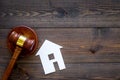 House cutout near judge gavel on dark wooden background top view copy space. Housing law. Property division. Real estate Royalty Free Stock Photo