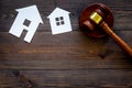 House cutout near judge gavel on dark wooden background top view copy space. Housing law. Property division. Real estate Royalty Free Stock Photo