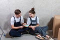 House decoration DIY renovation concept Happy couple sitting on floor in empty room of new home planning design. Husband Royalty Free Stock Photo