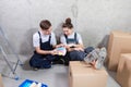 House decoration DIY renovation concept Happy couple sitting on floor in empty room of new home planning design. Husband Royalty Free Stock Photo