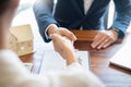 House developers agent or financial advisor and customers shaking hands after signing document making deal as successful Royalty Free Stock Photo