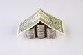 House from dollars costs on stacked coins Royalty Free Stock Photo