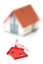House door key with red house key chain pendant and model house Royalty Free Stock Photo