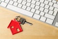 House door key with red house key chain pendant and computer key Royalty Free Stock Photo