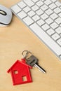 House door key with red house key chain pendant and computer key Royalty Free Stock Photo