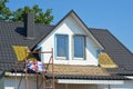 House dormer window insulation with white rigid foam boards during home renovation. House with new metal roof