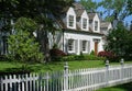 House with dormer windows and white picket fence