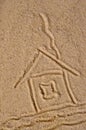 House drawing with a pipe on sea sand Royalty Free Stock Photo