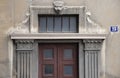 House entrance door with pillars and lion head above , detail of neoclassical architecture