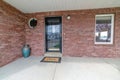 House entrance with glass storm door and front door against red brick wall Royalty Free Stock Photo