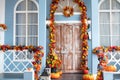 House entrance staircase decorated for autumn holidays, fall flowers and pumpkins. Cozy porch of house with pumpkins Royalty Free Stock Photo