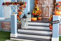 House entrance staircase decorated for autumn holidays, fall flowers and pumpkins. Royalty Free Stock Photo