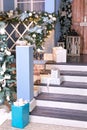 House entrance staircase decorated for winters holidays. Cozy wooden porch of the house with gift Royalty Free Stock Photo