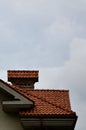 The house is equipped with high-quality roofing of ceramic tiles. A good example of perfect roofing. The building is reliably pro Royalty Free Stock Photo