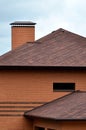 The house is equipped with high-quality roofing of shingles bitumen tiles. A good example of perfect roofing. The roof is reliabl Royalty Free Stock Photo