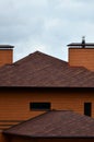 The house is equipped with high-quality roofing of shingles bitumen tiles. A good example of perfect roofing. The roof is reliabl Royalty Free Stock Photo