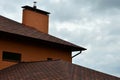 The house is equipped with high-quality roofing of shingles bitumen tiles. A good example of perfect roofing. The roof is reliabl Royalty Free Stock Photo