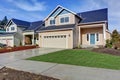 House exterior. American beige house with green grass.