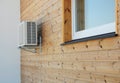 House exterior knotty pine, ceder wood wall siding and panel with air conditioner outdoor unit and window