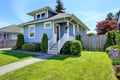 House exterior in light blue. View of front yard and entrance po Royalty Free Stock Photo