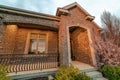 House exterior view with arched entrance on the gabled porch with brick wall Royalty Free Stock Photo