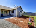 House exterior. Walkout deck with sawdust and flowers