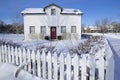 House exterior with the white picket fence in winter