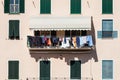 House facade with clothes hanging out to dry. Italian culture. Royalty Free Stock Photo