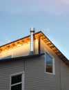 House Facade with outside pipe chimney in metal